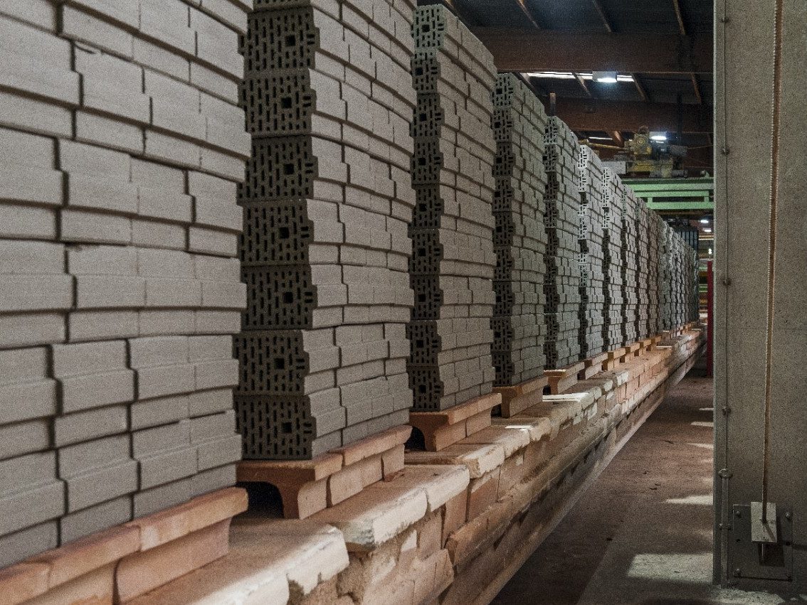 Dried clay block piles on kiln car on their way to the kiln