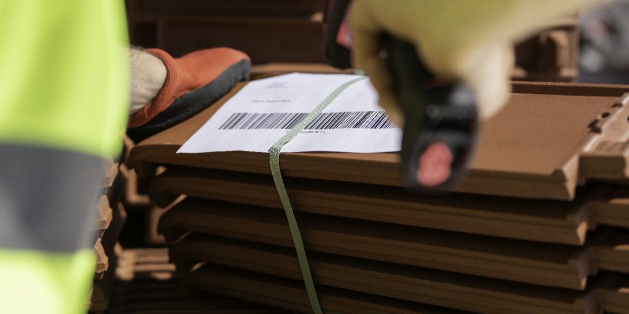 Stockyard employee scanning product codes