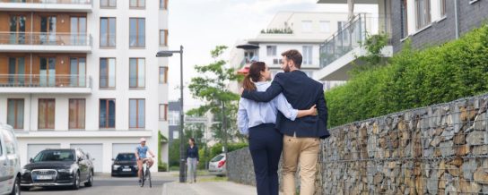Couple strolling down the street in a newly built housing estate