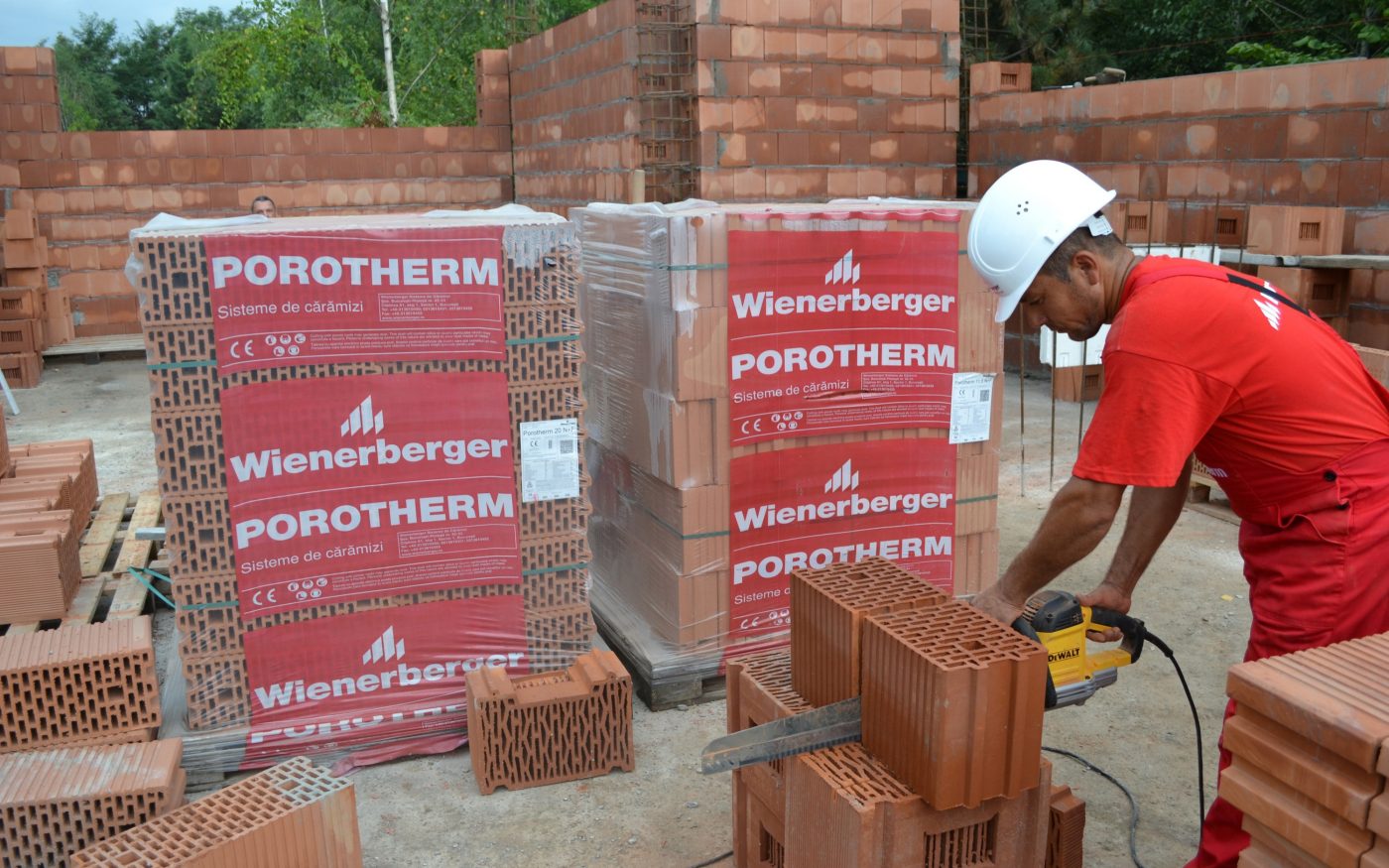 e4 brick House from Romania, worker cutting a brick in two